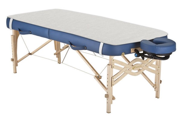 Professional electric heating blanket on massage table
